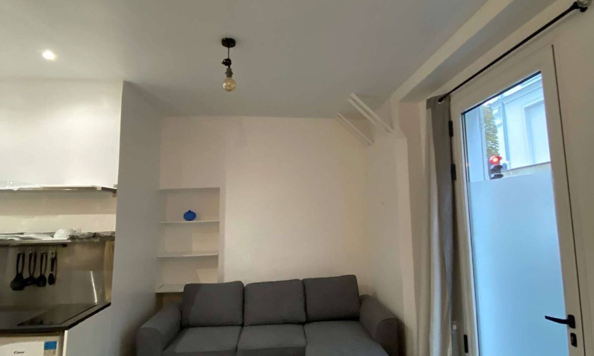 Quartier Saint-Georges Apartment | The apartment has a bed, a sofa bed and a kitchen with a refrigerator.