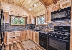 Remodeled lakeside resort cabin with fireplace, sandy beach, dock, firepit!