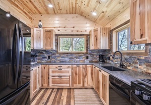 Remodeled lakeside resort cabin with fireplace, sandy beach, dock, firepit!