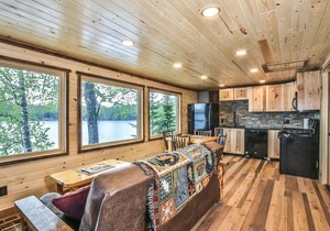 Remodeled lakeside resort cabin with fireplace, sandy beach, dock, firepit!