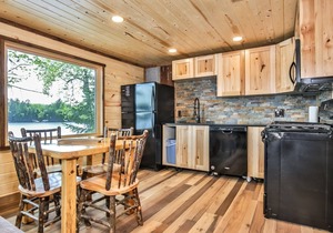 Remodeled lakeside resort cabin with fireplace, sandy beach, dock, firepit!