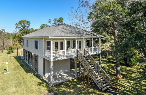 Henderson Point Cottage | Cozy Raised Cottage Overlooking Beautiful Bayou Mallini.