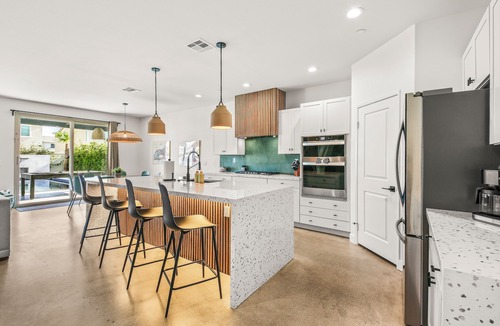 Coachella House | Escape to this newly remodeled 7-bedroom desert retreat designed for relaxation and fun. Enjoy a large resort-style pool and spa, a fully stocked kitchen, spacious game room, and outdoor games perfect for group play under endless blue skies. Whether