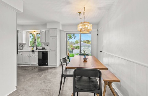 South Central Omaha House | Private hot tub + fire pit + screened in porch with character = your perfect starry nite escape