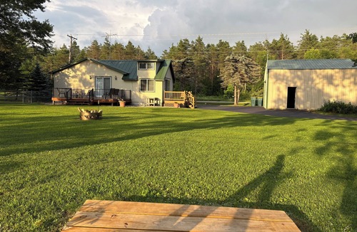 Nekoosa Cottage | Scenic riverfront cottage with boat landing and docks.