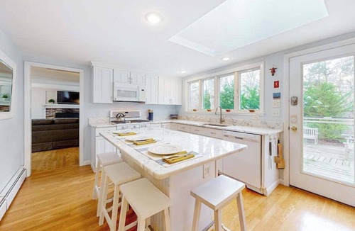 East Orleans House | Tranquil & sunlit home with peaceful yard, large deck, & fireplace - near beach